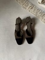 Chanel Suede Slingback sandal with a brown suede body and contrasting black toe cap