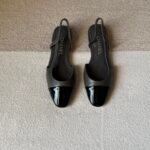 Chanel slingback shoes crafted "grey leather with black patent toe cap"
