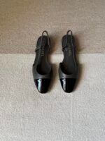 Chanel slingback shoes crafted "grey leather with black patent toe cap"