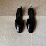Chanel slingback shoes crafted "black leather with black patent cap toe"