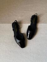 Chanel slingback shoes crafted "black leather with black patent cap toe" - Image 2