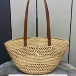 YSL "Saint Laurent Panier Small Bag in raffia with brown leather handle & a tonal Cassandre logo"