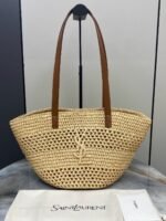 YSL "Saint Laurent Panier Small Bag in raffia with brown leather handle & a tonal Cassandre logo"