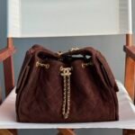 Chanel 25 handbag crafted from suede calfskin with gold-tone metal hardware