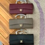 Chanel Lizard Embossed Calfskin Top Handle Long Clutch with iconic gold tone CC lock