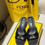 Fendi "Fold" Black leather kitten-heels sandals with gold-tone FF metal accent on the band
