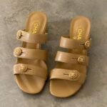 Chanel Mules in Beige Shiny Calfskin Leather with gold-tone CC turnlock logo on the straps