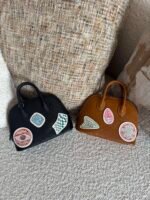 Hermès limited-edition Bolide mini pique-colle bags in noir & caramel mysore goatskin