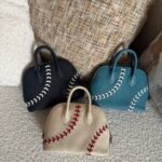 Hermès Baseball Bolide 45 bags in textured Evercolor leather showcase playful contrast-stitched lacing