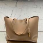 Saint Laurant East/West Supple Leather Shopper Tote with gleaming gold-tone cassandre charm detailing