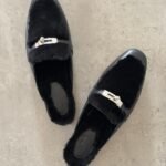 Hermès Oz Mules in Black, Crafted in tan leather with plush ecru shearling lining & a silver tone kelly buckle