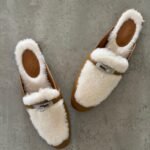 Hermès Oz Mules, Crafted in tan leather with plush ecru shearling lining & a silver tone kelly buckle
