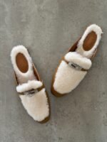 Hermès Oz Mules, Crafted in tan leather with plush ecru shearling lining & a silver tone kelly buckle